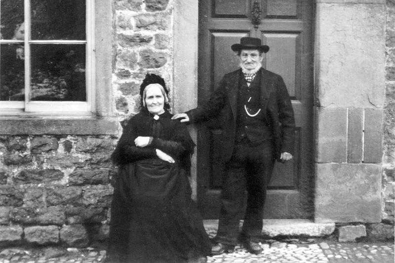 RS-D62 - Mr and Mrs Chapman - Endowed School Cottage - Main street.jpg - Mr & Mrs Chapman posing outside The Cottage, Main Street - Endowed Schools Cottage. Great grand parents of Nancy Procter   (- date not known ) 